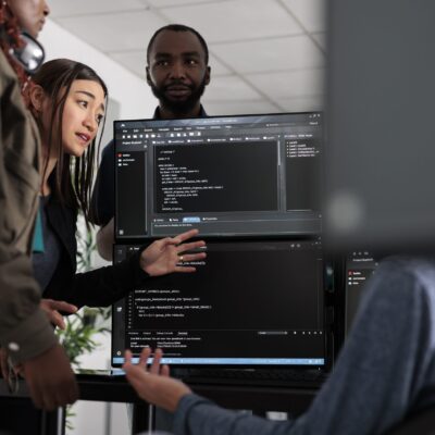 Team of system engineer writing data and discussing about coding language, analyzing server code and database. IT engineers working with cloud computing terminal window in software company
