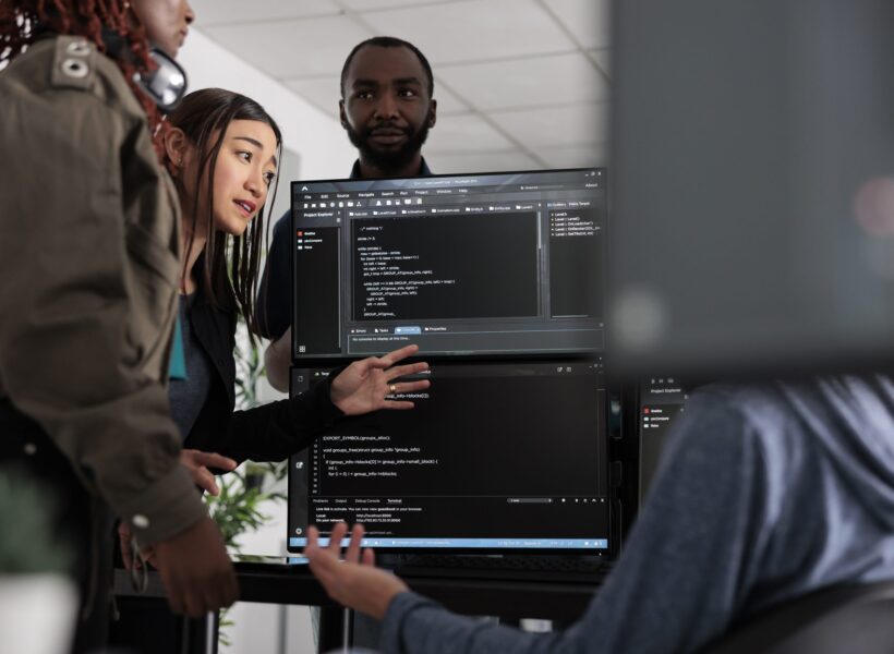 Team of system engineer writing data and discussing about coding language, analyzing server code and database. IT engineers working with cloud computing terminal window in software company