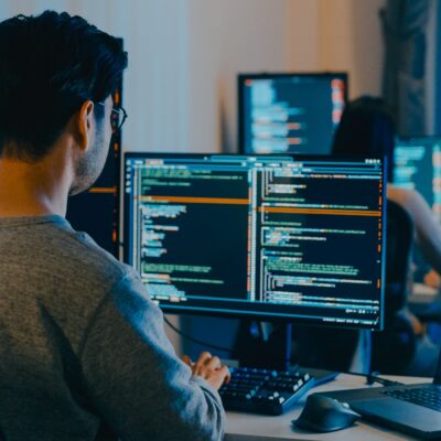 Group Adult Asia male, female freelance typing write prompt AI bot IT app smart program nomad, video game, terminal with coding language, designer, big data center on desktop computer in night office.